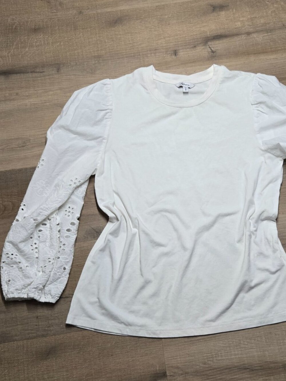 Reitmans white eyelet long sleeve blouse with detail on sleeves.